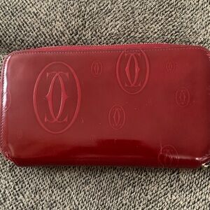 This is a Cartier Happy Birthday Round Zip Long Wallet in red patent leather